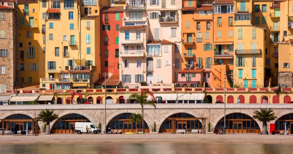 Shoreline with bright, colorful buildings by the beach in French Rivera.