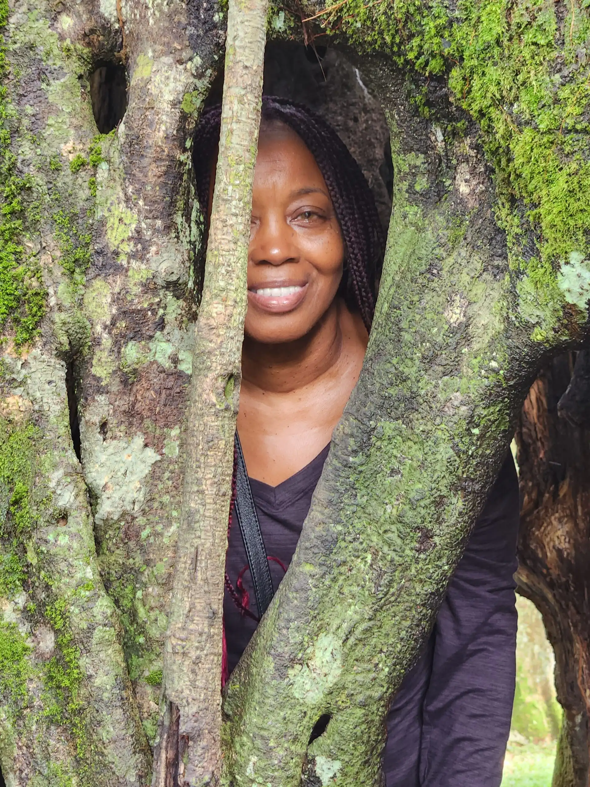 Woman peeking through trees