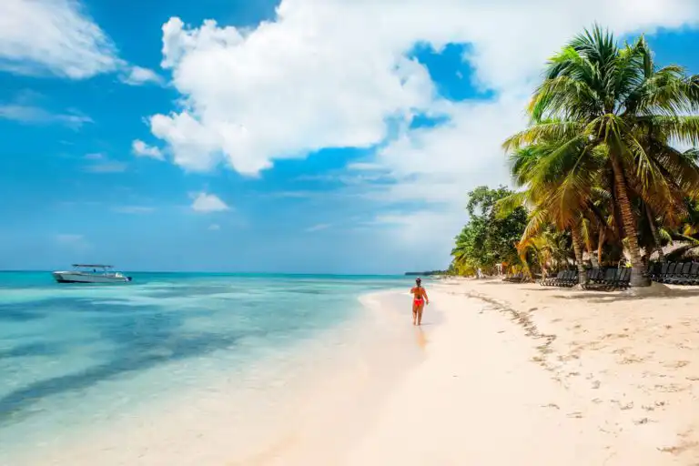 Tropical beach with person walking